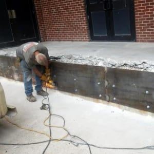 Working on a metal retaining wall