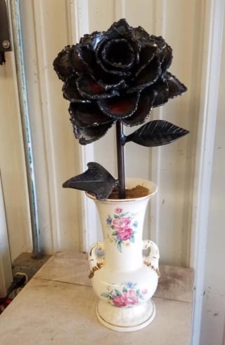 A metal flower in a vase