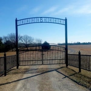 Gate leading to a long curvy dirt road